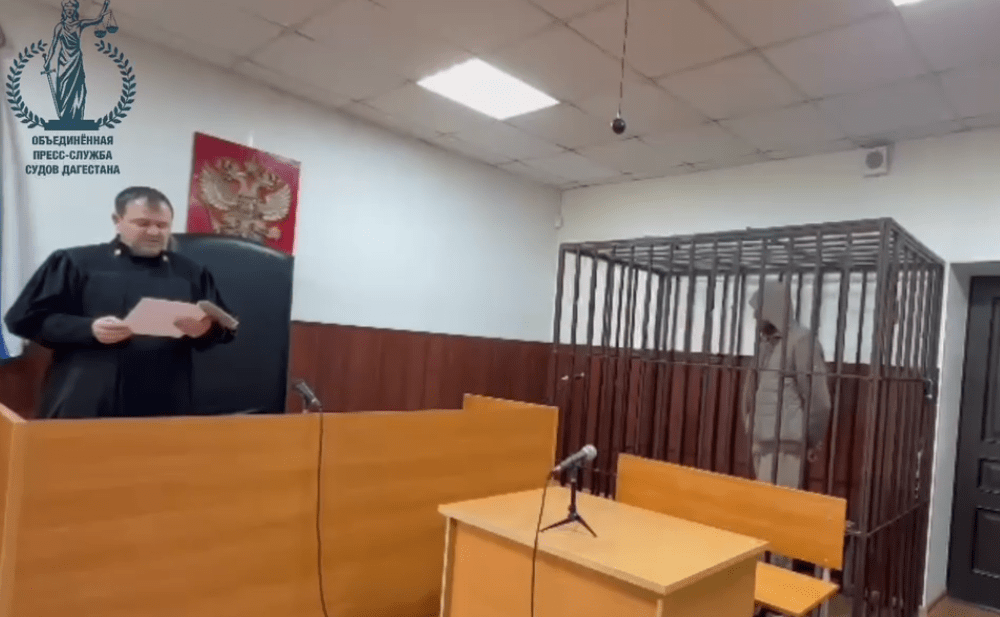 Судья и арестованный в зале суда. Стоп-кадр видео Telegram-канала "Фемида Дагестана" от 12.04.25, https://t.me/Femida_Dagestana/67.