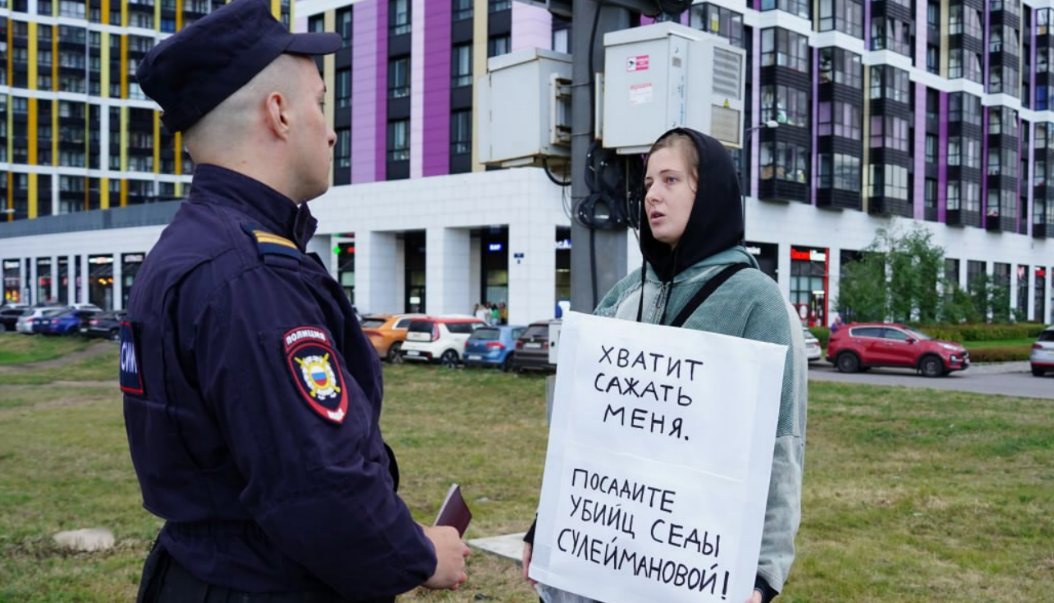Лена Патяева беседует с сотрудником полиции. Скриншот фото "Слово защите" от 23.08.25, https://t.me/endoflaw/1183.